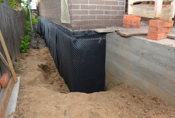 Happy homeowners after waterproofing job in Dyer